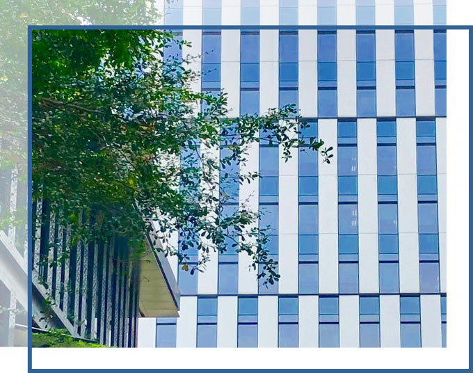 insurance-claims-disputes-commercial-property-claims-lawyer-florida-gadc-law Side of building with trees in the foreground | Commercial Property Claims Lawyer GD&C Law