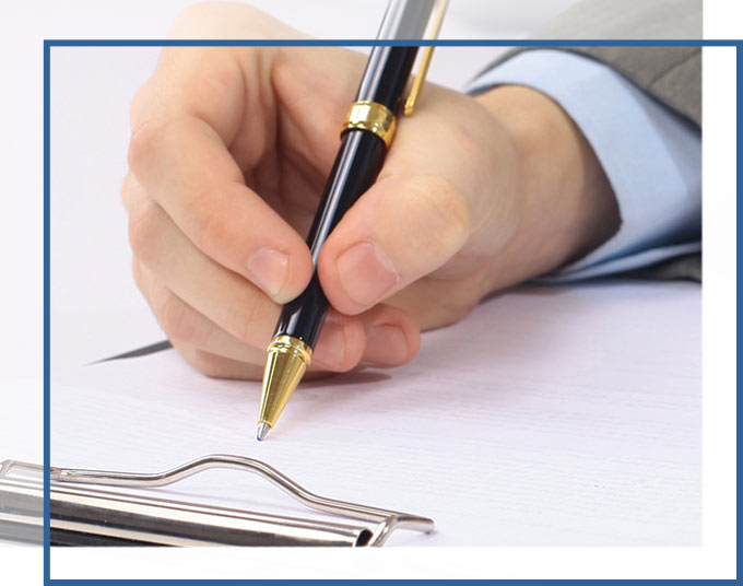 Arm of Businessman Taking Notes on paper attached to clipboard | Probate and Trust Administration Lawyers GD&C Law