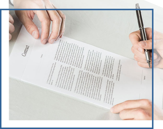 Hands reviewing and signing contract | Real Estate Contract Review & Negotiations Services from the Attorneys of GD&C Law
