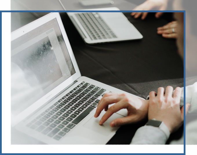 People using laptops at a desk | Succession Planning Lawyers GD&C Law